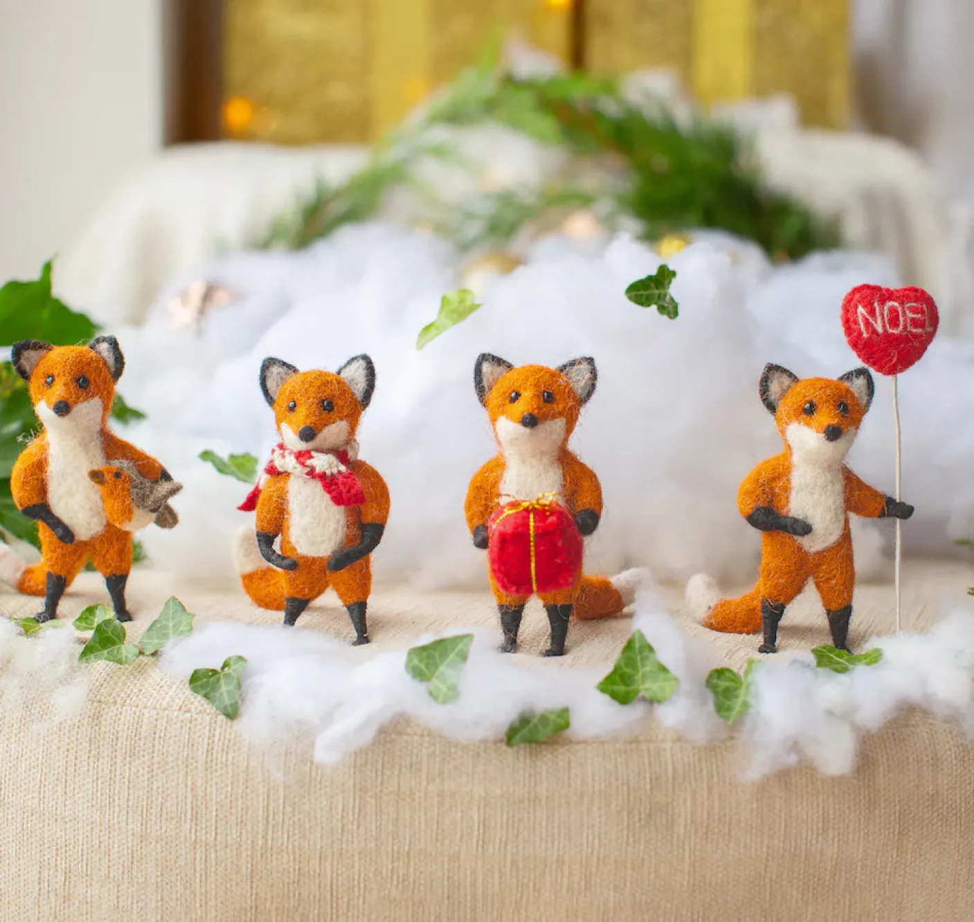 Hunter Fox Holding Holding a Robin Felt Decoration